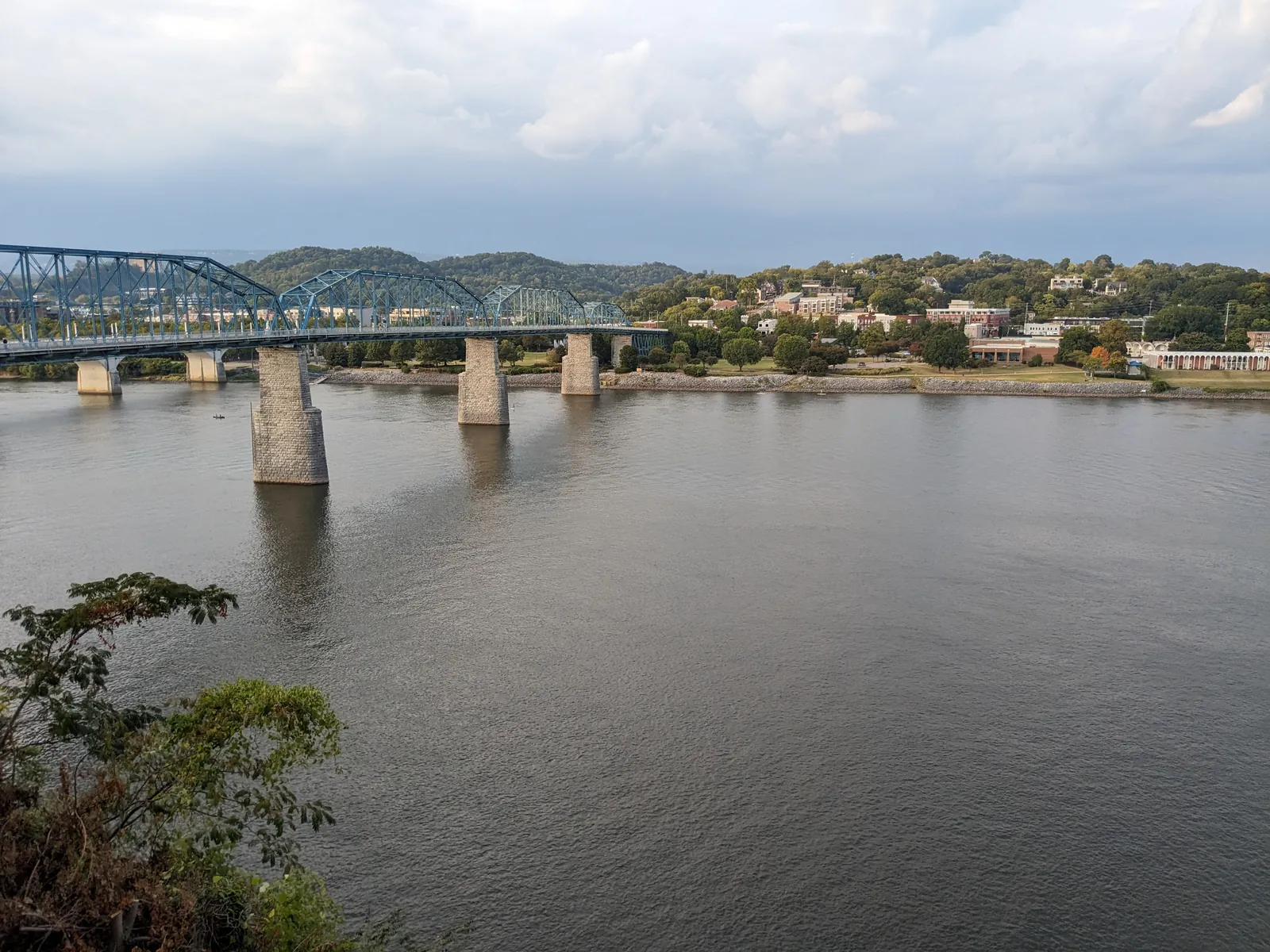 The blue Walnut Street Bridge spanning the Tennessee River toward the North Shore, viewed from the Bluff View area above the Riverwalk
